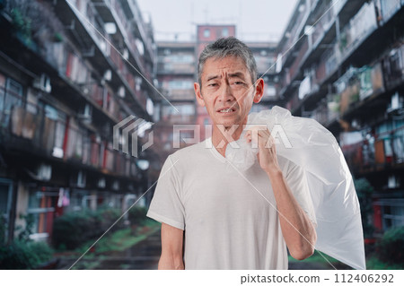 homeless man picking up trash homeless man picking up trash 112406292