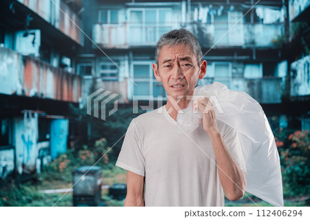 homeless man picking up trash 112406294