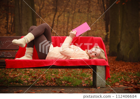 Blonde girl with red book. 112406684