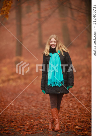 Attractive woman in autumnal park. 112406732