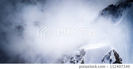 A stunning view with the snowy mountains and clouds. A stunning view with the snowy mountains and clouds. 112407140
