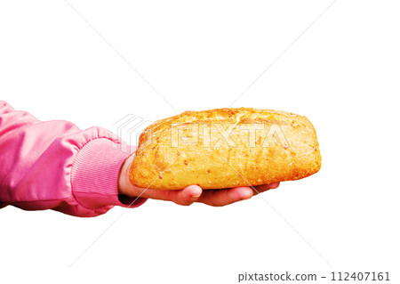 Bread in the hand of a middle-aged woman. The concept of the world food crisis associated with the war in Ukraine. Isolated on white background Bread in the hand of a middle-aged woman. The concept of the world food crisis associated with the war in Ukraine. Isolated on white background 112407161