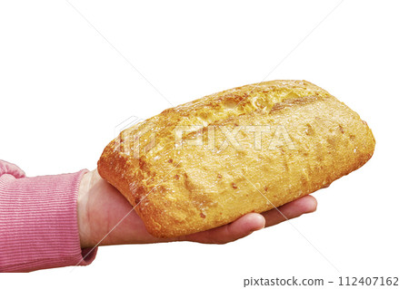 Bread in the hand of a middle-aged woman. The concept of the world food crisis associated with the war in Ukraine. Isolated on white background Bread in the hand of a middle-aged woman. The concept of the world food crisis associated with the war in Ukraine. Isolated on white background 112407162