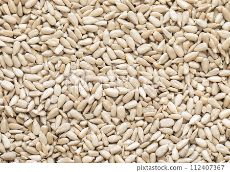 Healthy peeled sunflower seeds top view macro background. Healthy peeled sunflower seeds top view macro background. 112407367