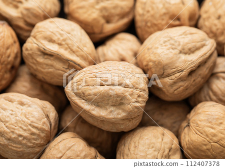 Raw healthy shell walnut nuts top view macro background. 112407378
