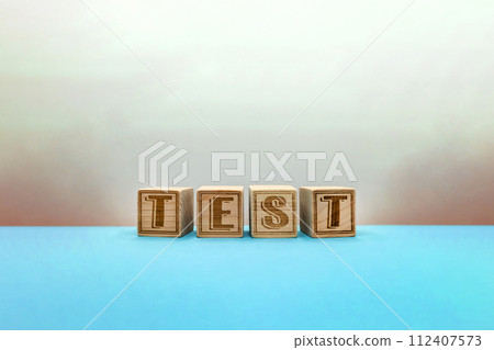 TEST alphabet blocks glowing suspiciously on a light blue background TEST alphabet blocks glowing suspiciously on a light blue background 112407573