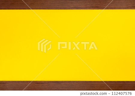 A yellow background with two strips of vintage-style brown wood at the top and bottom. A yellow background with two strips of vintage-style brown wood at the top and bottom. 112407576
