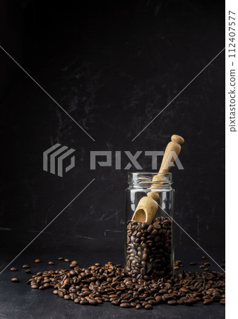 coffee on a dark background.Coffee time. Coffee break. Coffee in a clear glass. Jar with  beans.  112407577