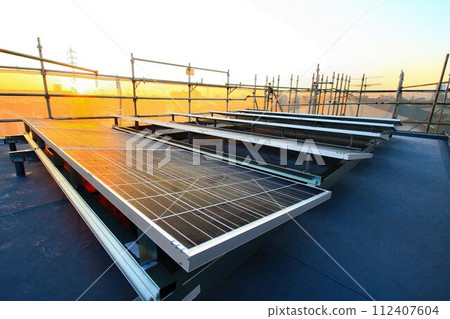 Flat roof under construction... [Solar power generation panels] installed on a pedestal 112407604