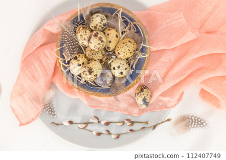 Quail eggs in a ceramic bowl 112407749