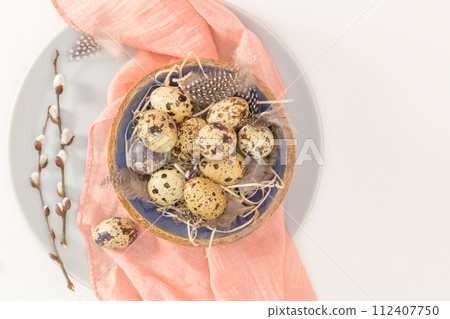 Quail eggs in a ceramic bowl 112407750