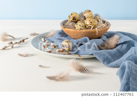 Quail eggs in a ceramic bowl 112407761