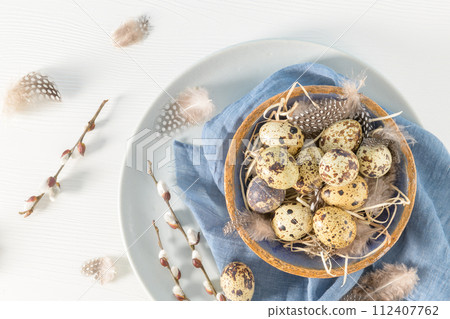 Quail eggs in a ceramic bowl 112407762