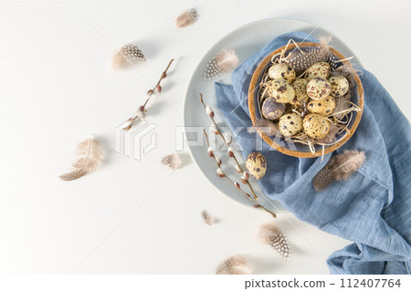 Quail eggs in a ceramic bowl 112407764