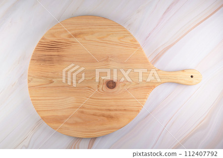Wooden cutting board on a gray marble background Wooden cutting board on a gray marble background 112407792