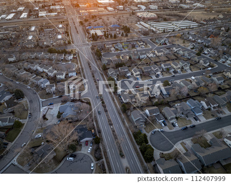 winter sunrise over a street with morning traffic and residential area of Fort Collins in northern Colorado, aerial view winter sunrise over a street with morning traffic and residential area of Fort Collins in northern Colorado, aerial view 112407999