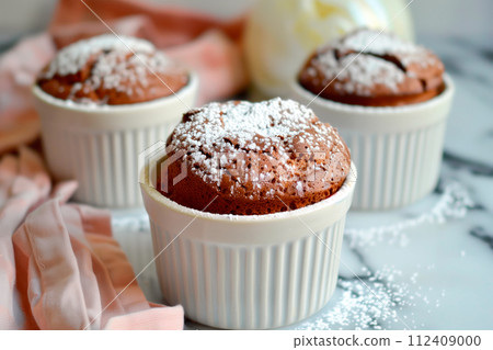 A freshly baked chocolate lava cake with a molten center. Chocolate cake or fondant powdered sugar on top A freshly baked chocolate lava cake with a molten center. Chocolate cake or fondant powdered sugar on top 112409000