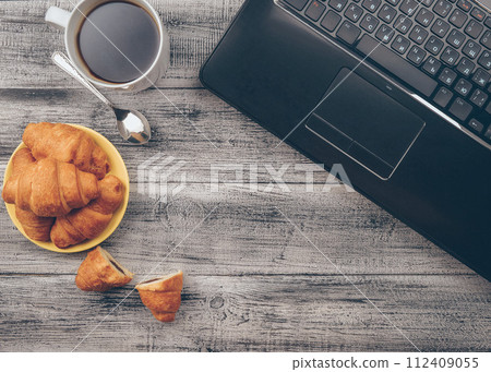 Croissants close-up. Delicious hot fresh pastries. Freshly baked croissants. Croissants . Coffee. 112409055