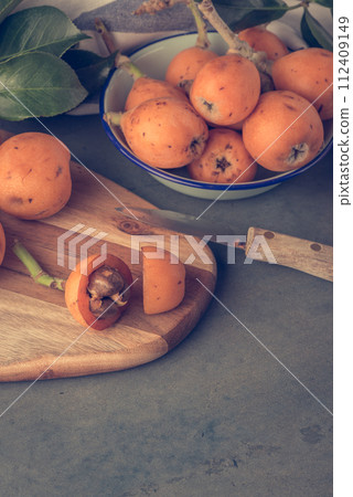 loquats on kitchen counter loquats on kitchen counter 112409149