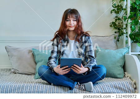 Young trendy girl using digital tablet for studying communication leisure Young trendy girl using digital tablet for studying communication leisure 112409972