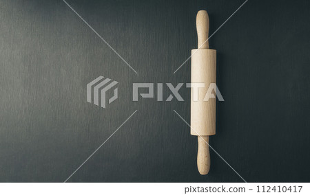 close up of various baking utensils for baking cookies , like rolling pin whisk and baking pan 112410417