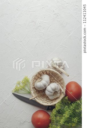 Tomatoes, cucumbers, dill and garlic on a light background. The concept of healthy lifestyle. Tomatoes, cucumbers, dill and garlic on a light background. The concept of healthy lifestyle. 112411045