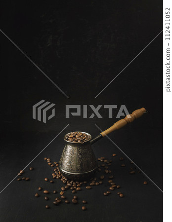 coffee concept. Coffee beans in Cezve. on the table, hot and fresh morning coffee. roasted coffee. coffee concept. Coffee beans in Cezve. on the table, hot and fresh morning coffee. roasted coffee. 112411052