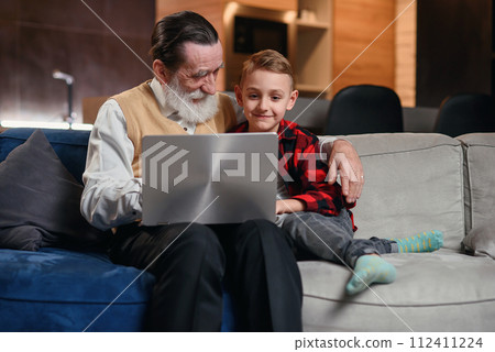 Grandson is teaching his grandfather to use laptop computer. Grandson is teaching his grandfather to use laptop computer. 112411224
