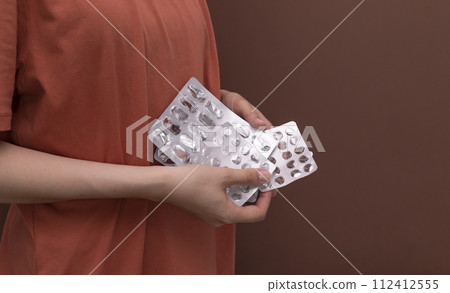 Design White Cropped Woman Holds Empty Medicine Blisters. Antidepressants, Drugs Addiction. Horizontal Plane. Space For Text. Pharmacy. Design White Cropped Woman Holds Empty Medicine Blisters. Antidepressants, Drugs Addiction. Horizontal Plane. Space For Text. Pharmacy. 112412555