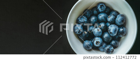 Freshly picked blueberries in a bowl. Juicy and fresh berries on a rustic table. Healthy food 112412772