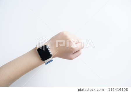 Woman's hand wearing a smartwatch Woman's hand wearing a smartwatch 112414108