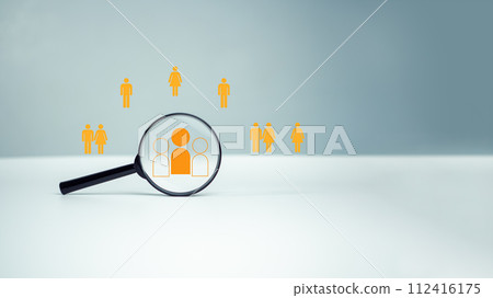 Customer group icons in a magnifying glass placed on a white background represent the selection of business goals, target customers, Marketing plans and strategies, customer-centric strategies. 112416175