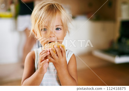 Little girl eating a sesame bun. High quality photo 112418875