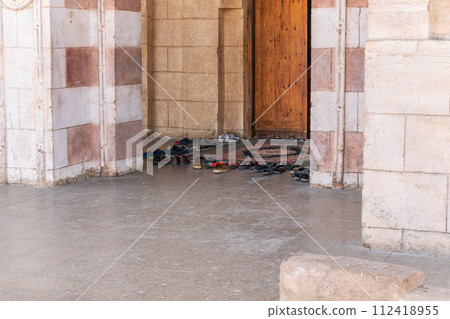 Believers' shoes left in front of the entrance to the Muslim mosque. 112418955