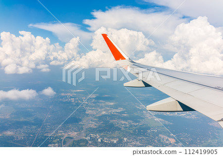 View from the airplane window during taking off on a clear summer morning View from the airplane window during taking off on a clear summer morning 112419905