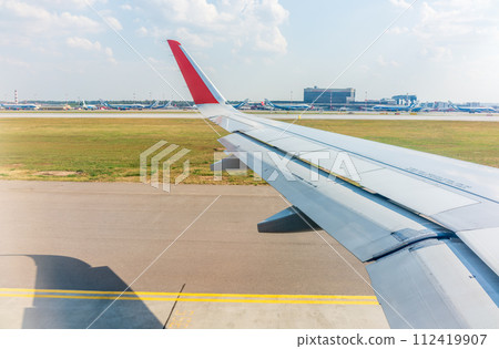 View from the airplane window during takeoff at Sheremetyevo airport at summer View from the airplane window during takeoff at Sheremetyevo airport at summer 112419907