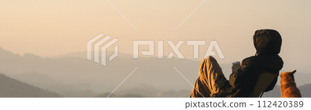 nature traveling with solo man play with dog and see sunrise with layer of mountain nature traveling with solo man play with dog and see sunrise with layer of mountain 112420389