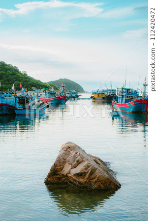 fishing boats moored in the sea 112420472