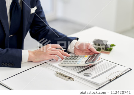 Businessman calculating money related to real estate 112420741