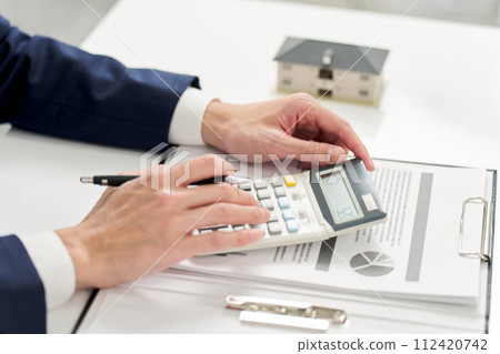 Businessman calculating money related to real estate 112420742