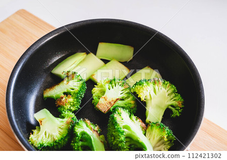 Broccoli fried in a frying pan Broccoli fried in a frying pan 112421302
