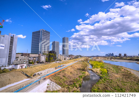 Tokyo cityscape in Japan March...Tama River and bank protection construction near Futakotamagawa Station. On the right is the tower apartment complex in front of Musashikosugi Station. Tokyo cityscape in Japan March...Tama River and bank protection construction near Futakotamagawa Station. On the right is the tower apartment complex in front of Musashikosugi Station. 112421749