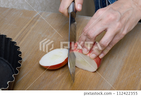 A white-skinned woman's hands while making apple pie in her home kitchen. A white-skinned woman's hands while making apple pie in her home kitchen. 112422355