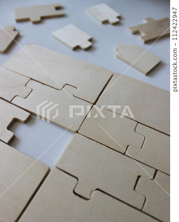 One missing piece in a rectangle assembled from wooden puzzles One missing piece in a rectangle assembled from wooden puzzles 112422947