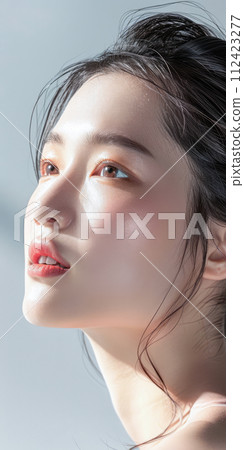 Young Asian woman portrait showcasing her skin care with a a copy space background Young Asian woman portrait showcasing her skin care with a a copy space background 112423277