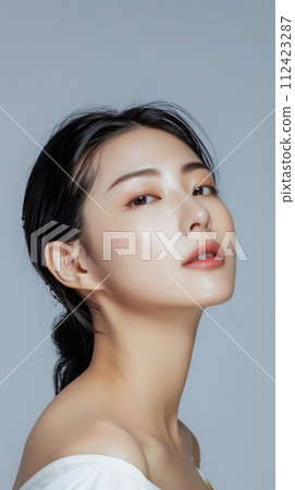 Young Asian woman portrait showcasing her skin care with a a copy space background Young Asian woman portrait showcasing her skin care with a a copy space background 112423287