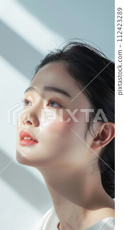 Young Asian woman portrait showcasing her skin care with a a copy space background 112423289