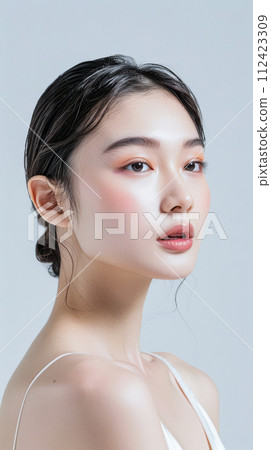 Young Asian woman portrait showcasing her skin care with a a copy space background Young Asian woman portrait showcasing her skin care with a a copy space background 112423309
