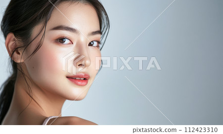 Young Asian woman portrait showcasing her skin care with a a copy space background Young Asian woman portrait showcasing her skin care with a a copy space background 112423310