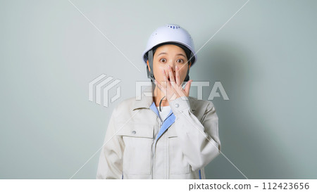 A surprising woman wearing work clothes 112423656